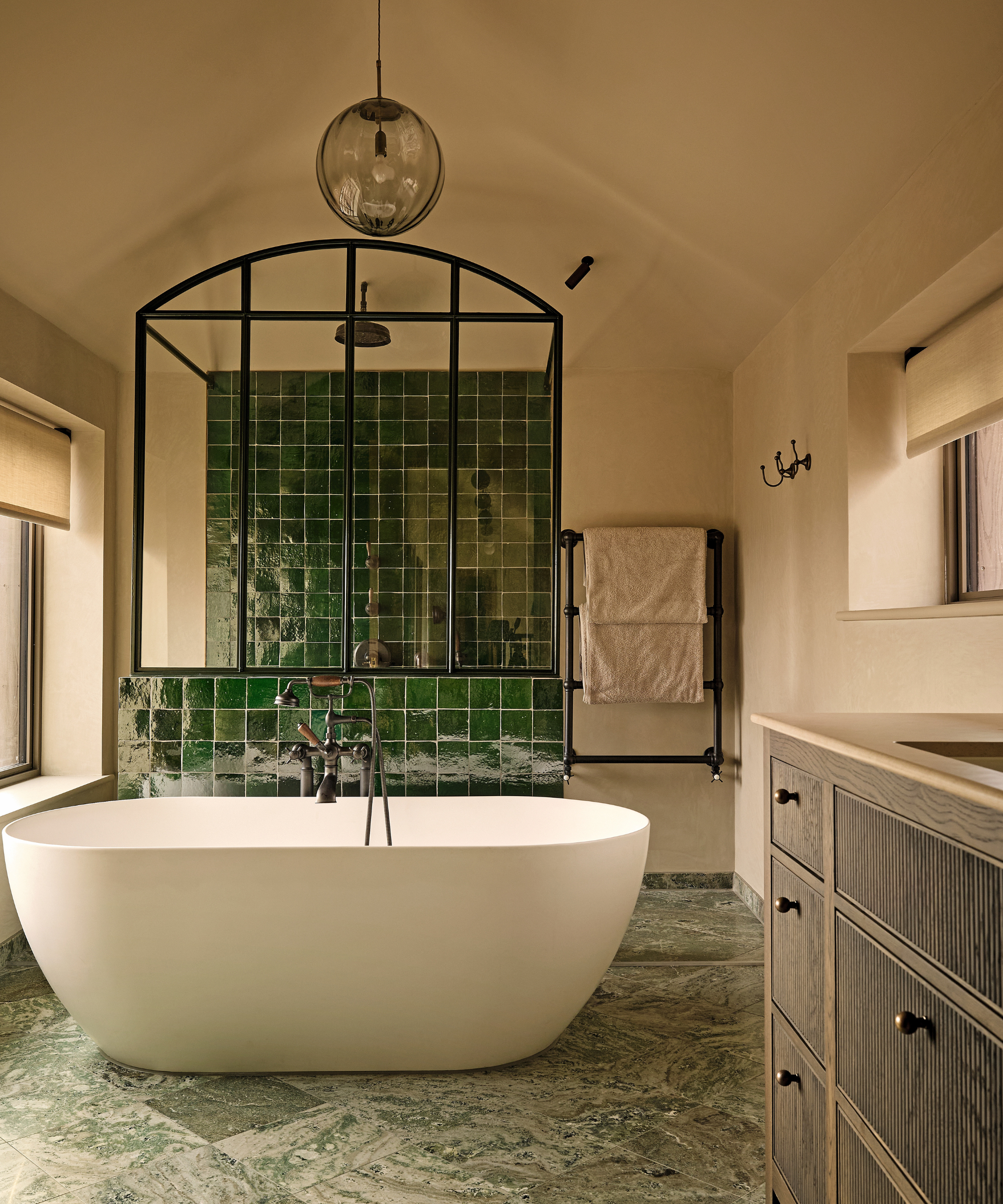 modern bathroom with bath and green tiles