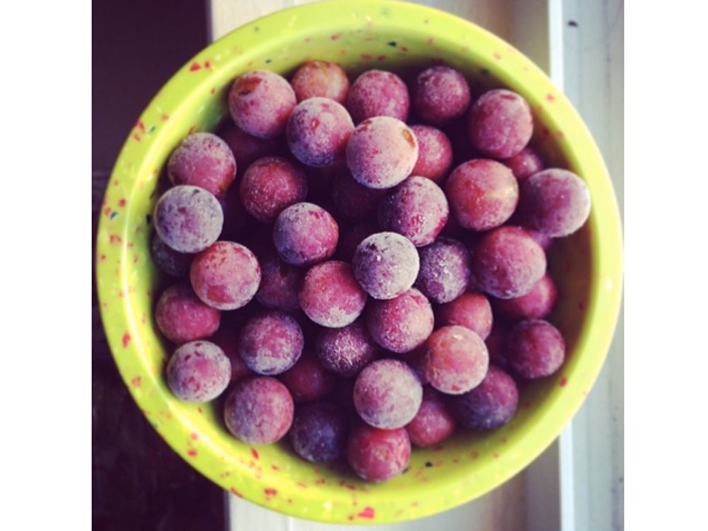 Frozen red grapes in a bowl