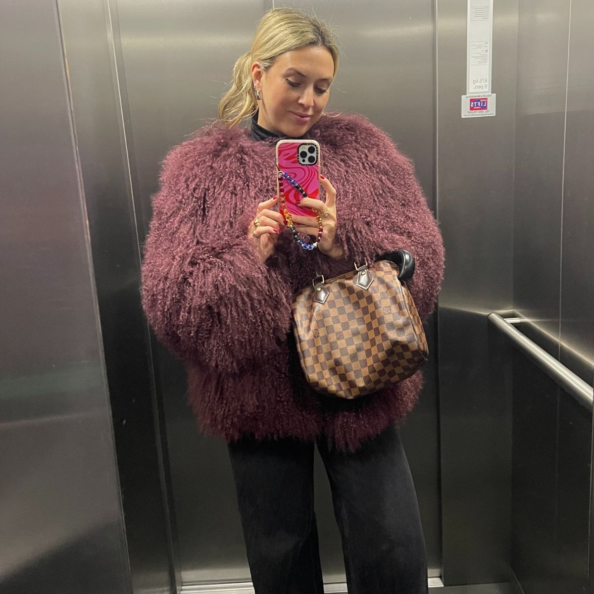 clementina jackson wears agolde black low curve jeans and a mongolian coat