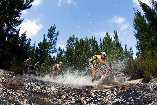 Stage winner Kevin Evans leads through a water crossing in the Watervalberg area