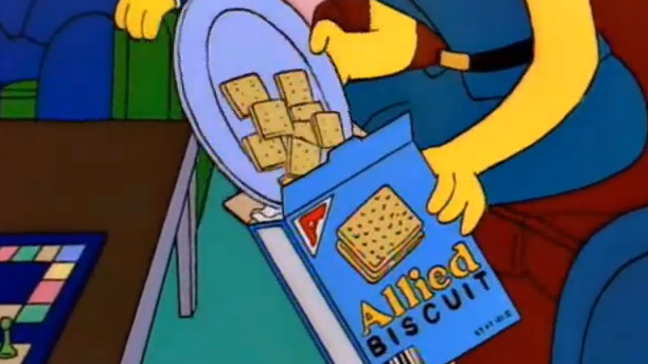 Marge dumping crackers into an Allied Biscuits box in The Simpsons