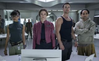 Four crew members aboard a futuristic spaceship