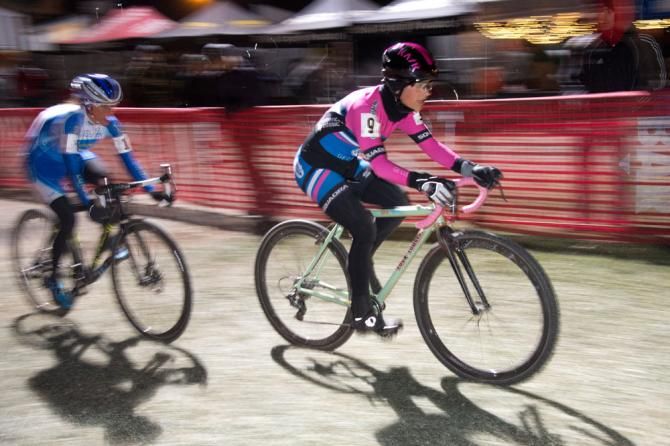 Courtney McFadden leads Nash down the finish straight with one lap to go.