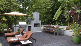 Garden area with built in outdoor kitchen and seating and area with two recliners