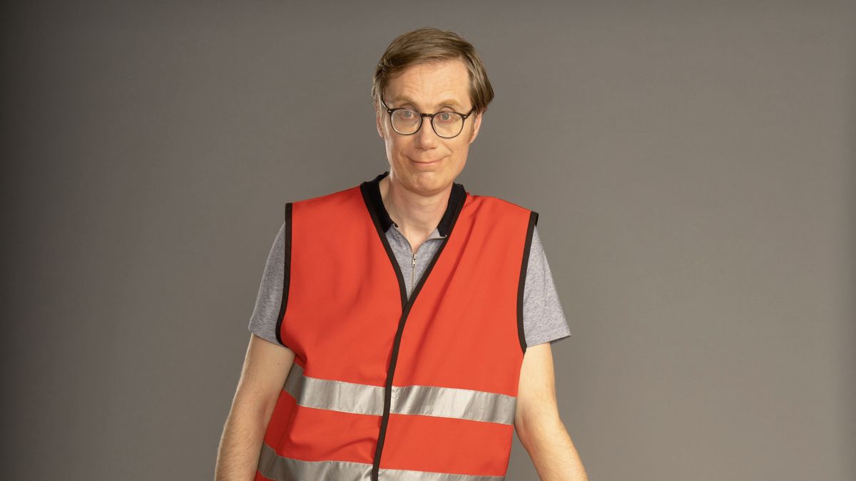 Stephen Merchant in an orange hi-vis vest as Greg in The Outlaws.