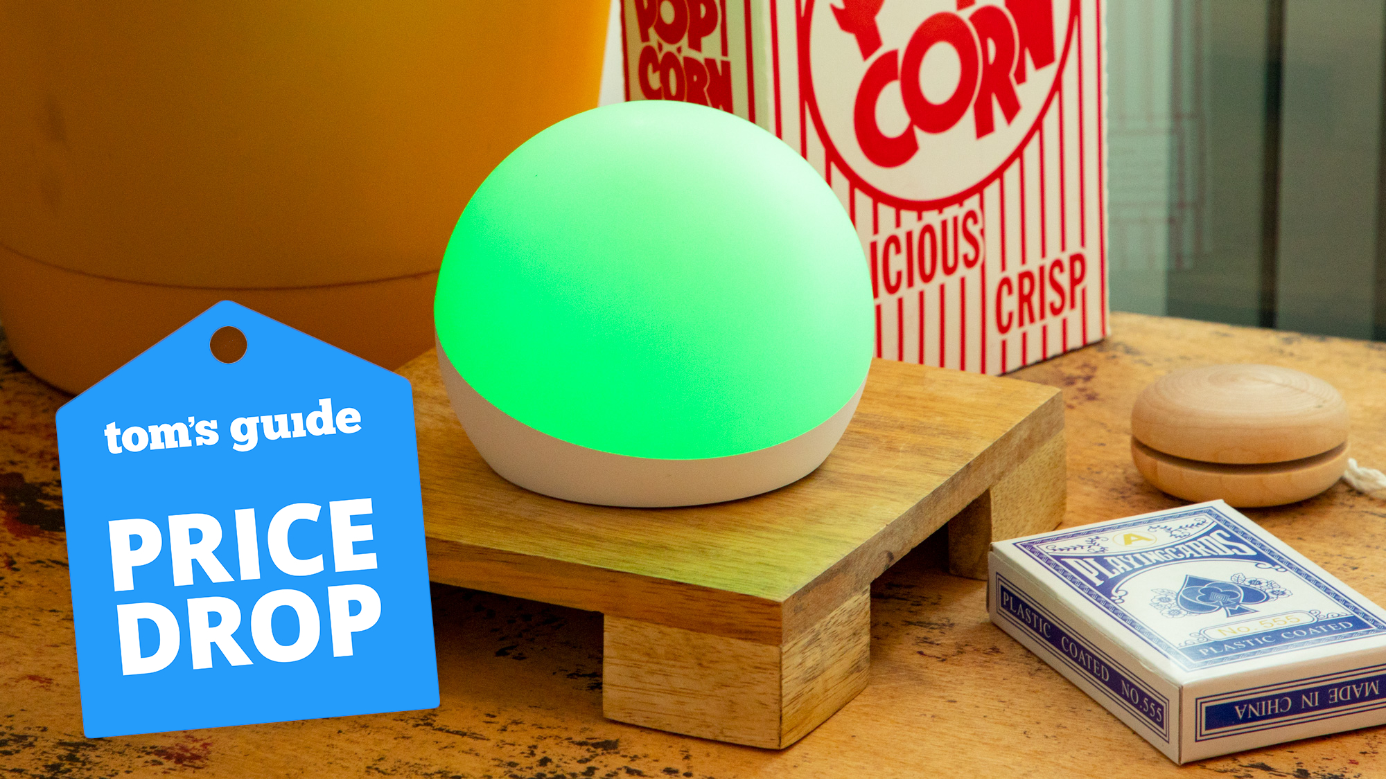 An Echo Glow light on a table with a Tom's Guide Price Drop deals badge on top