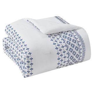 A folded blue and white patterned bedding set