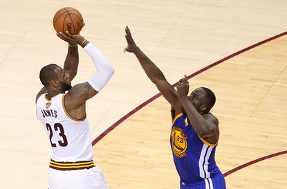 LeBron James of the Cleveland Cavaliers gets ready to shoot over Draymond Green of the Golden State Warriors.