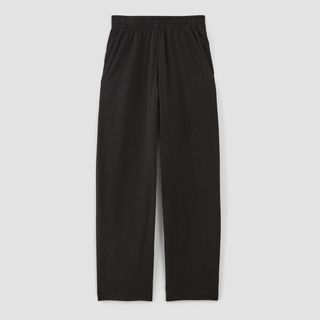 A cutout of black barrel leg track pants