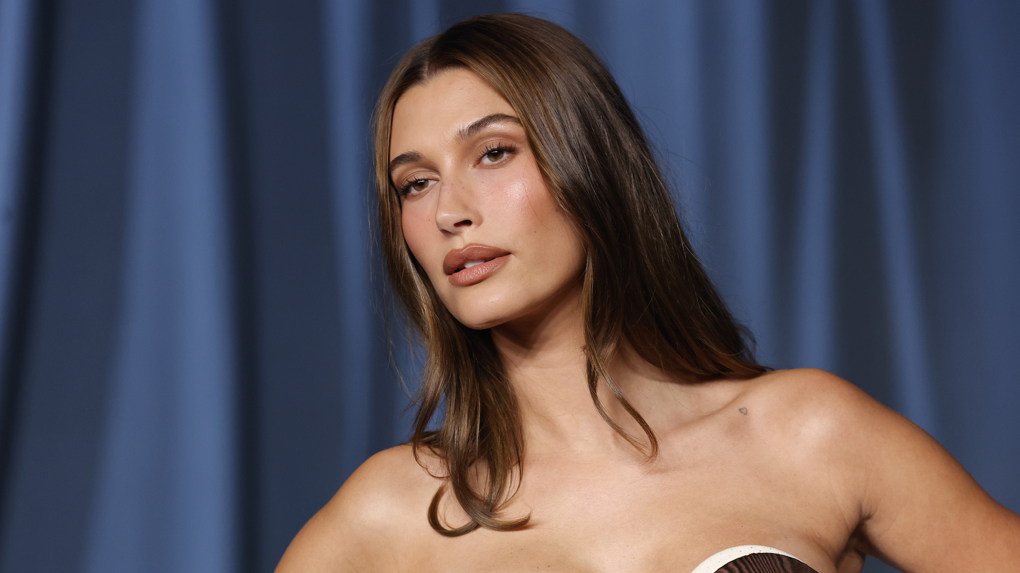 Hailey Bieber with brunette colour melt hair and strapless dress