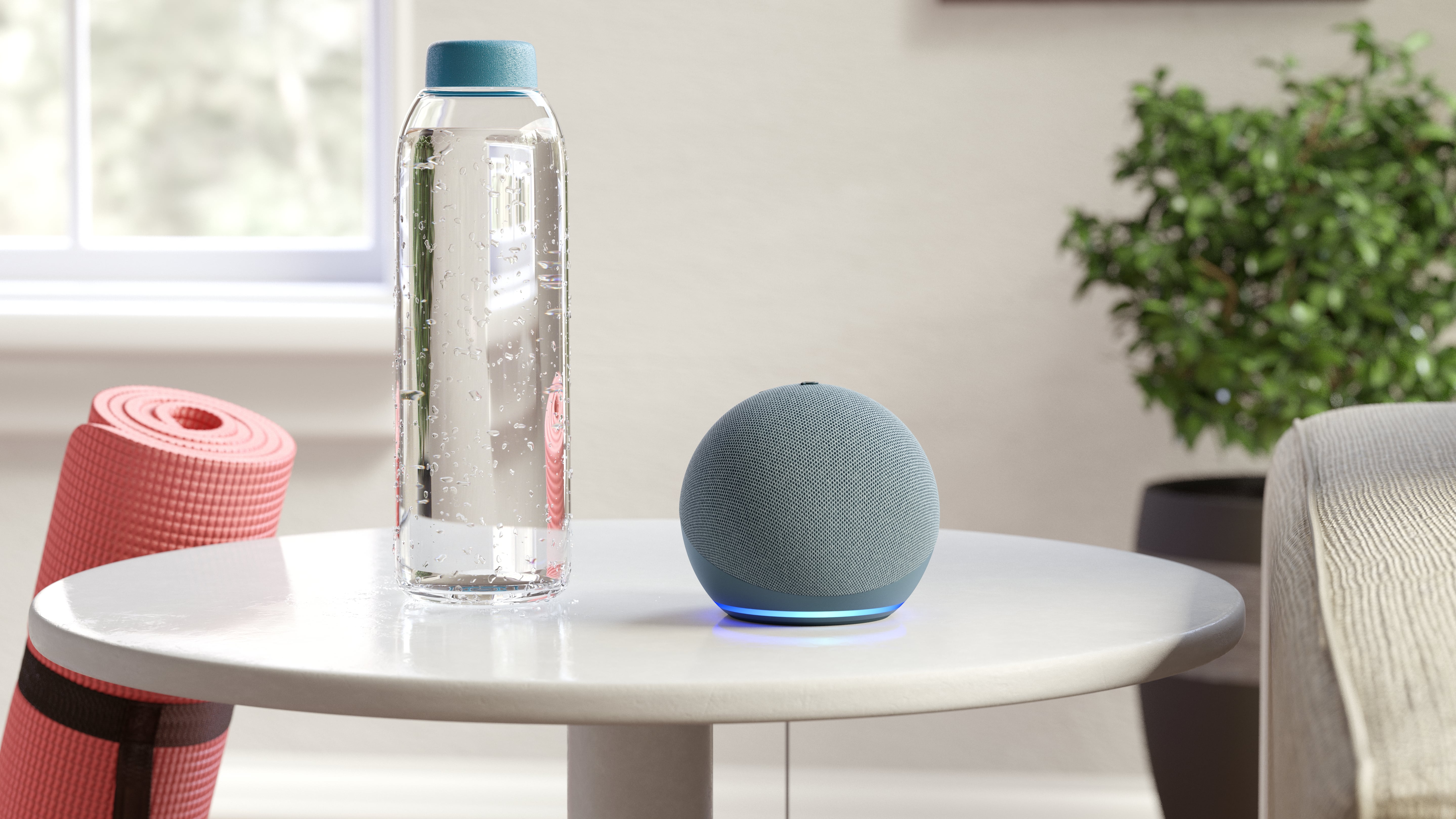 The Echo Dot sitting on a table next to a water bottle and a yoga mat.