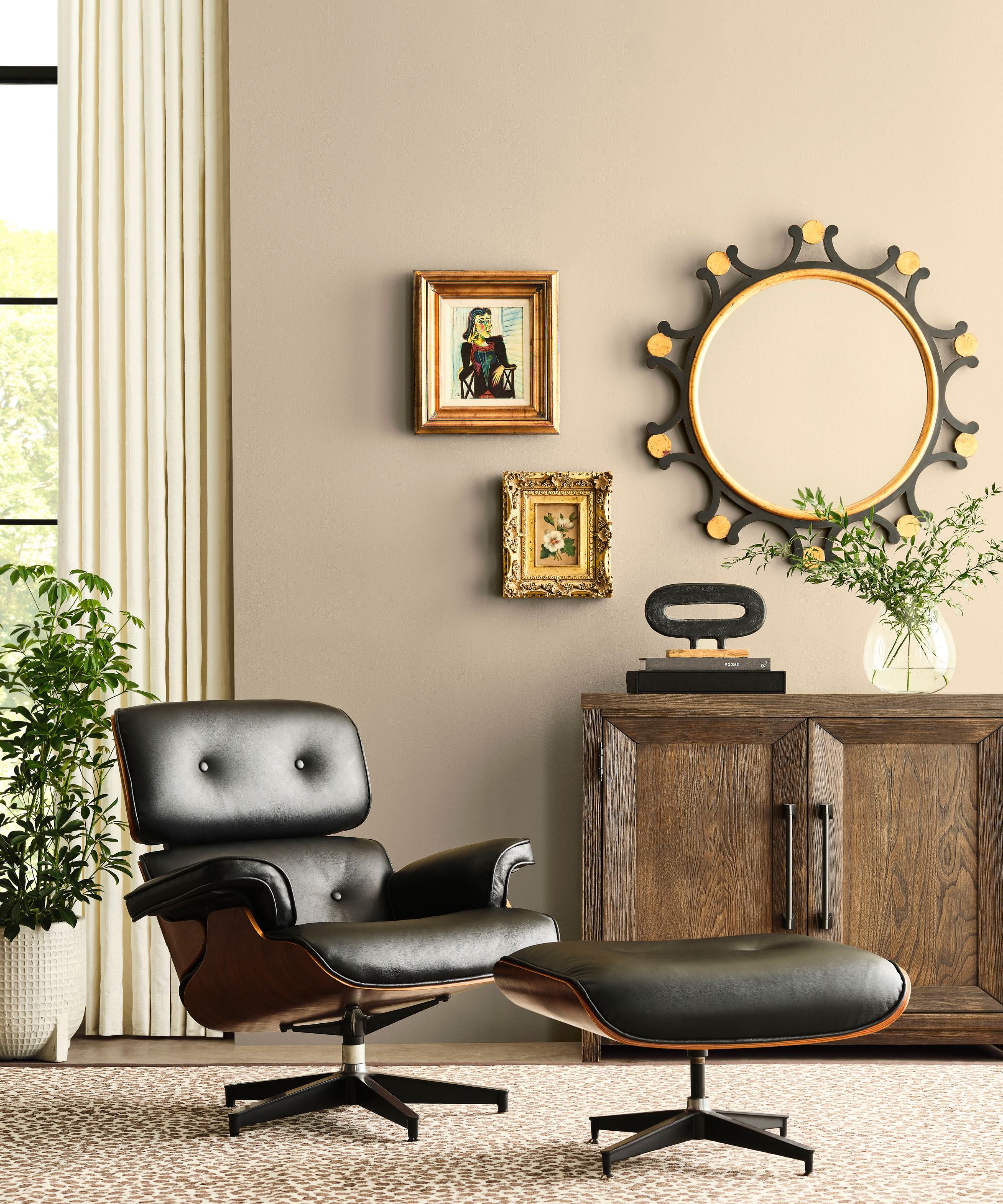 Room painted in Sherwin-Williams Universal Khaki with a wooden side table in the background and a retro leather chair and footstool