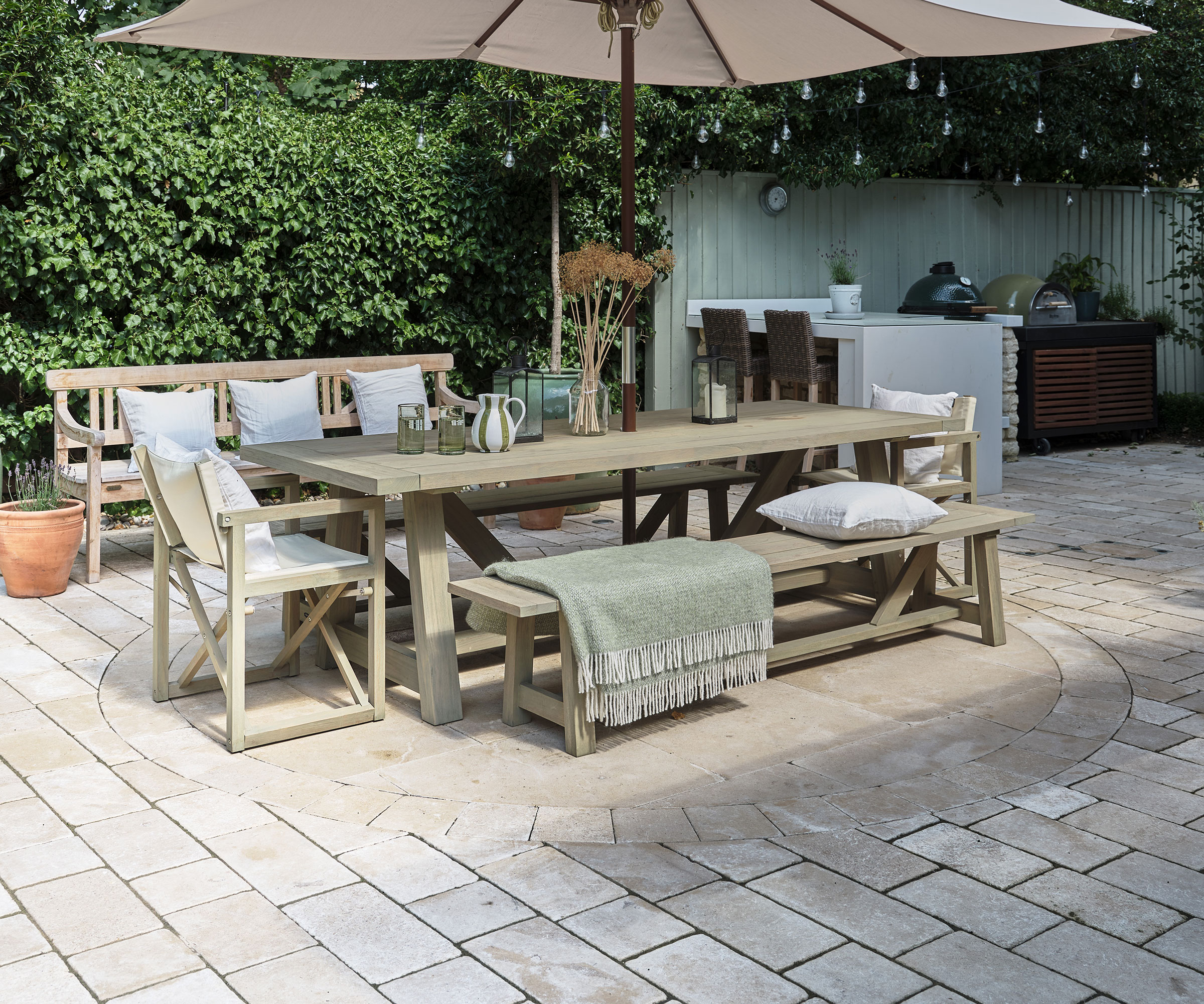 outdoor dining area with limestone tiles and outdoor seating with outdoor kitchen