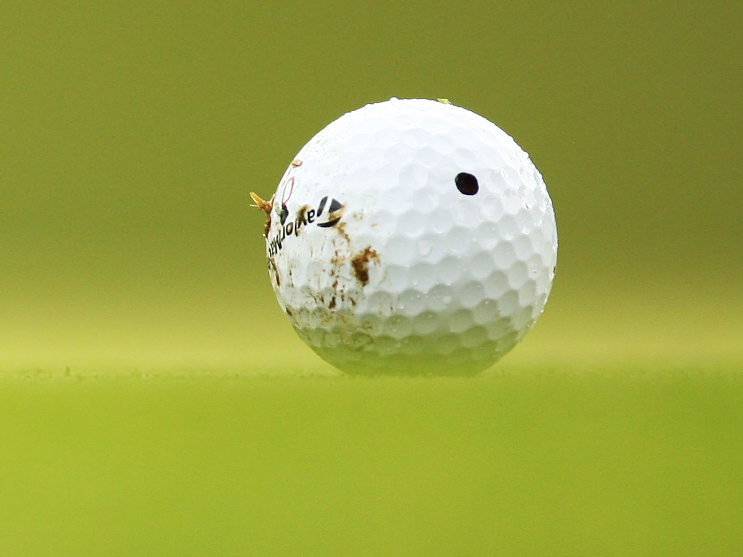 Golf ball with mud on it