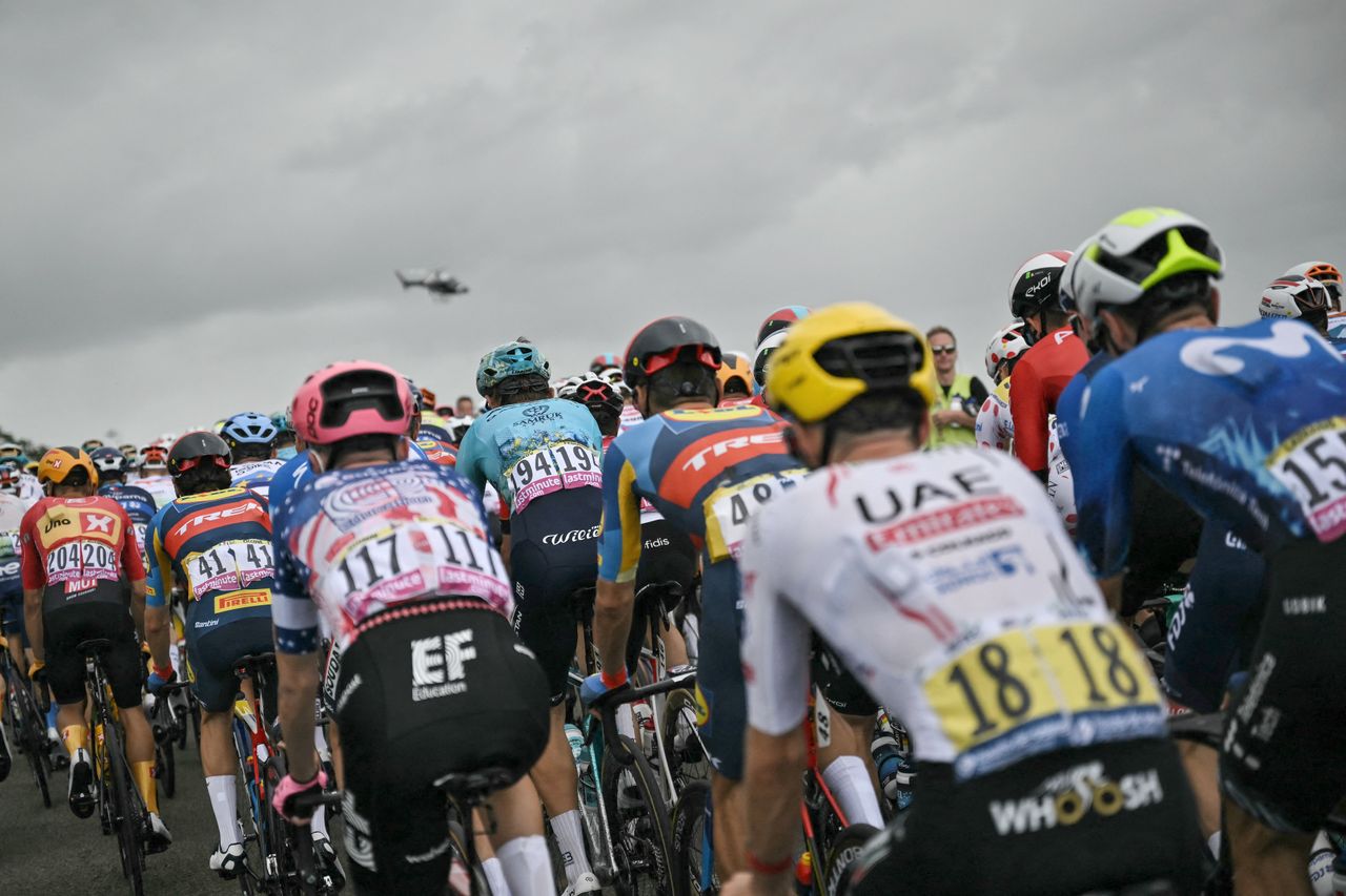 A helicopter hovers over the Tour de France 2024 peloton