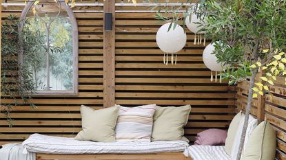 Outdoor seating area with cushions and decorations