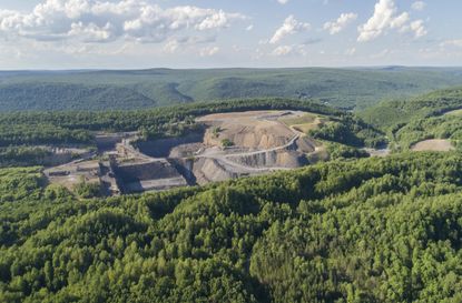 The aerial view from a drone to the open-cast mine in Lehigh Valley, Carbon County, Pennsylvania, USA. The sunny summer day.