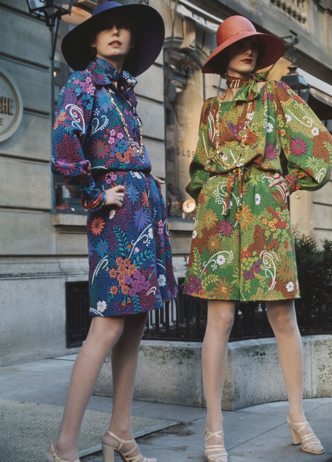 Two models pose in floral-print silk crepe dresses from French designer Guy Laroche's spring/summer collection in Paris, France, on February 1st, 1974. (Photo by UPI/Bettmann Archive/Getty Images)