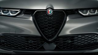 Detail of grill and badge on front of Alfa Romeo Tonale compact SUV