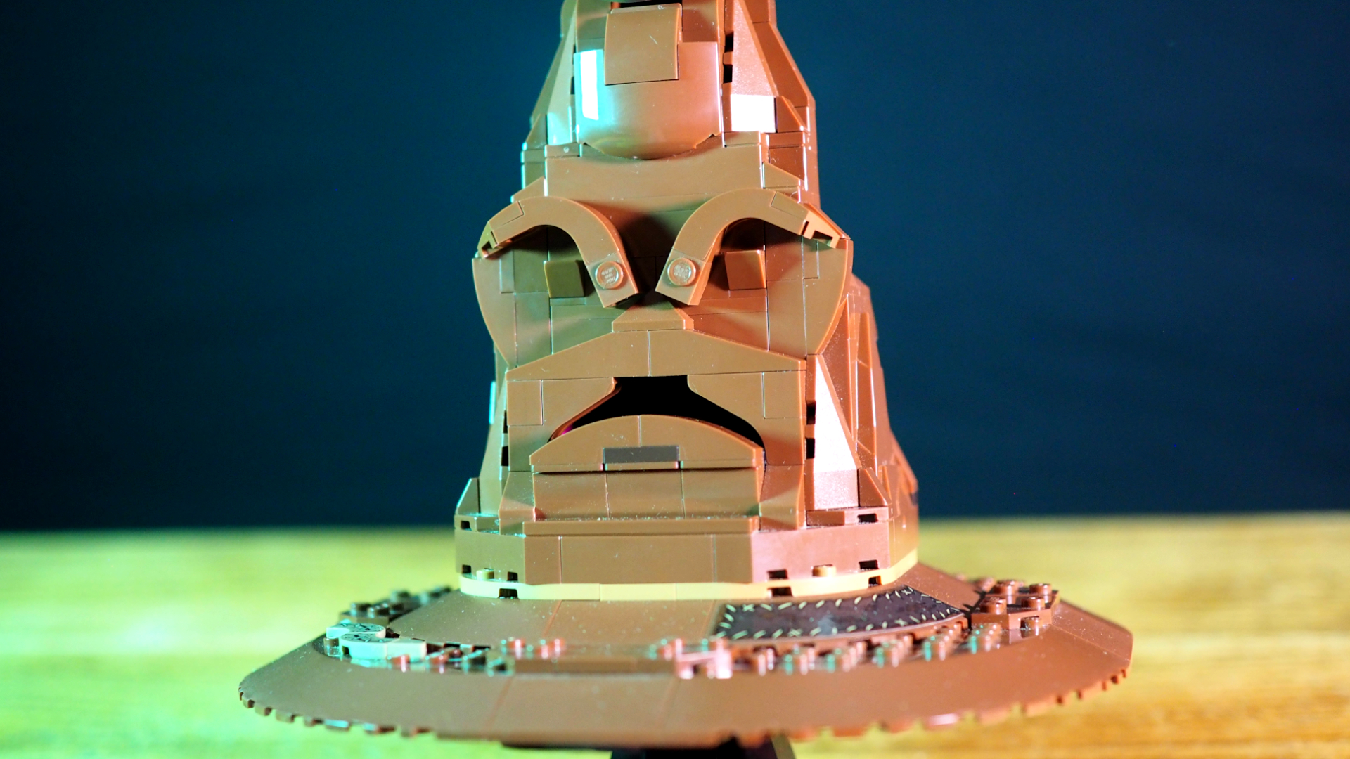 Lego Talking Sorting Hat on a wooden table, seen straight on