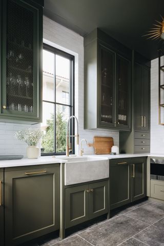 butler walk-in pantry with olive green kitchen cabinets