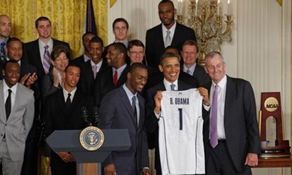 President Obama poses with the 2011 NCAA Champion University of Connecticut team: The NCAA is vowing major changes to college sports' rules but critics are doubtful.