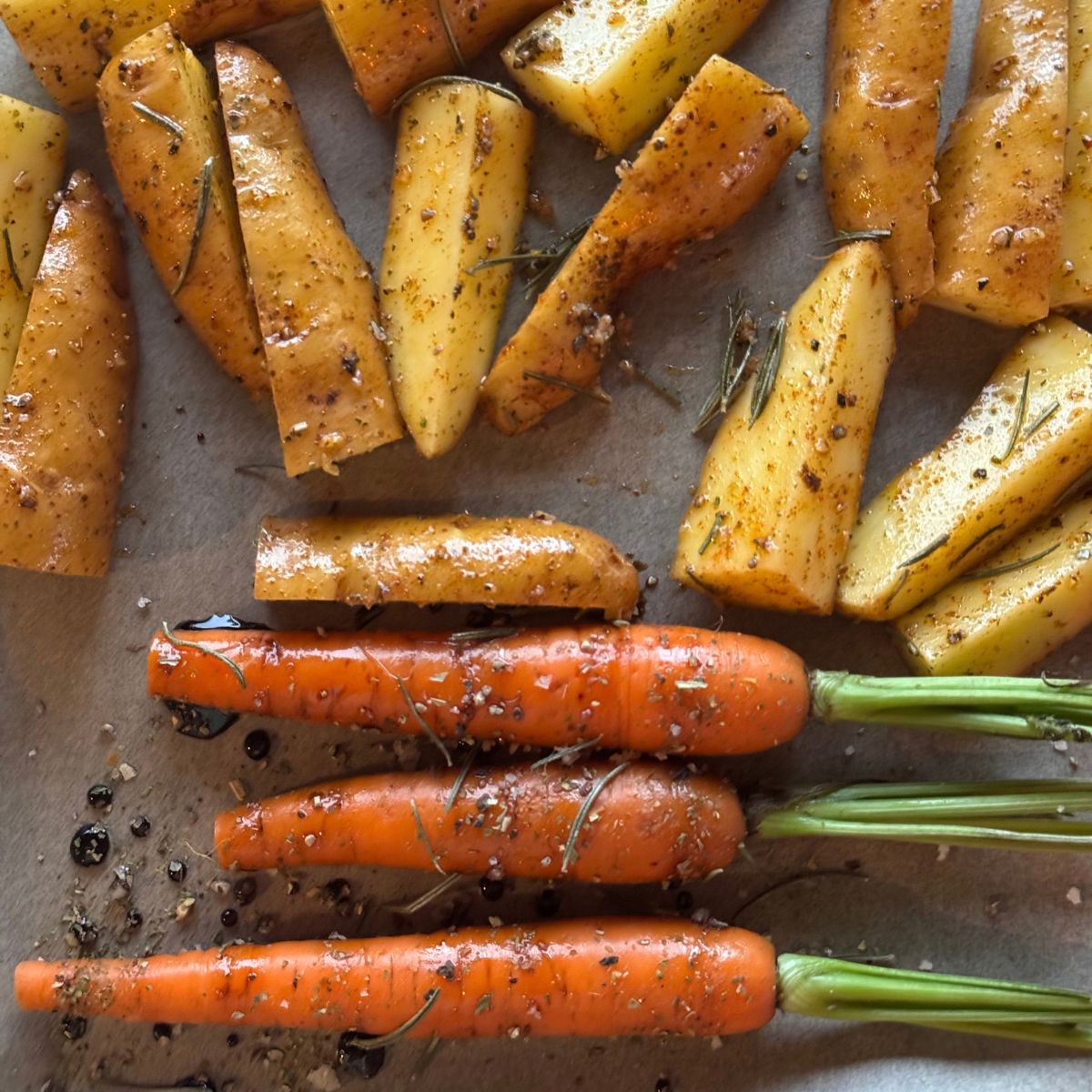 Roasted carrots, parsnips, and onions: A chopping board with vegetables on for chicken soup