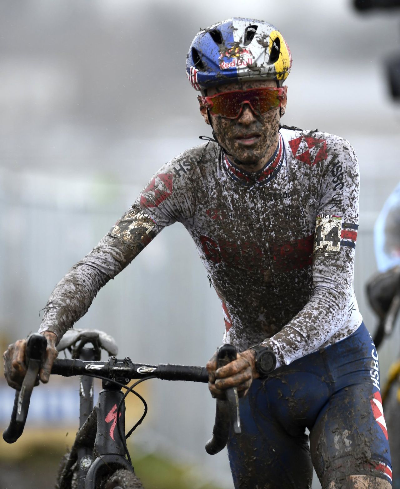 Tom Pidcock caked in mud