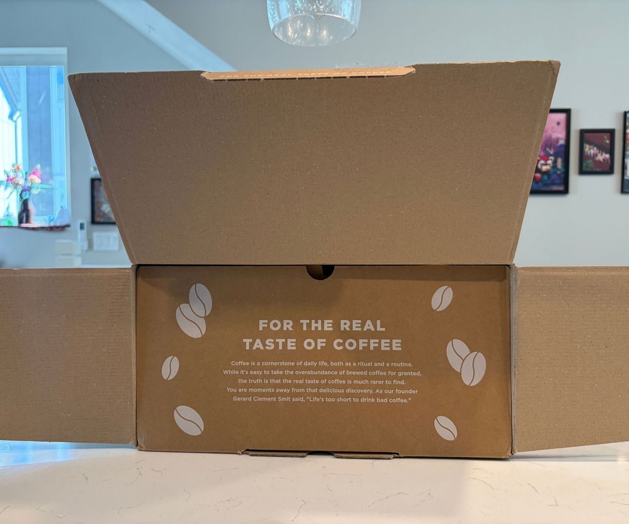 The Moccamaster Cup-One cardboard box open on a white counter.