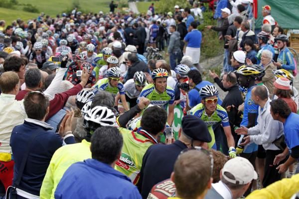 Liquigas-Doimo lead the peloton over a climb packed with spectators