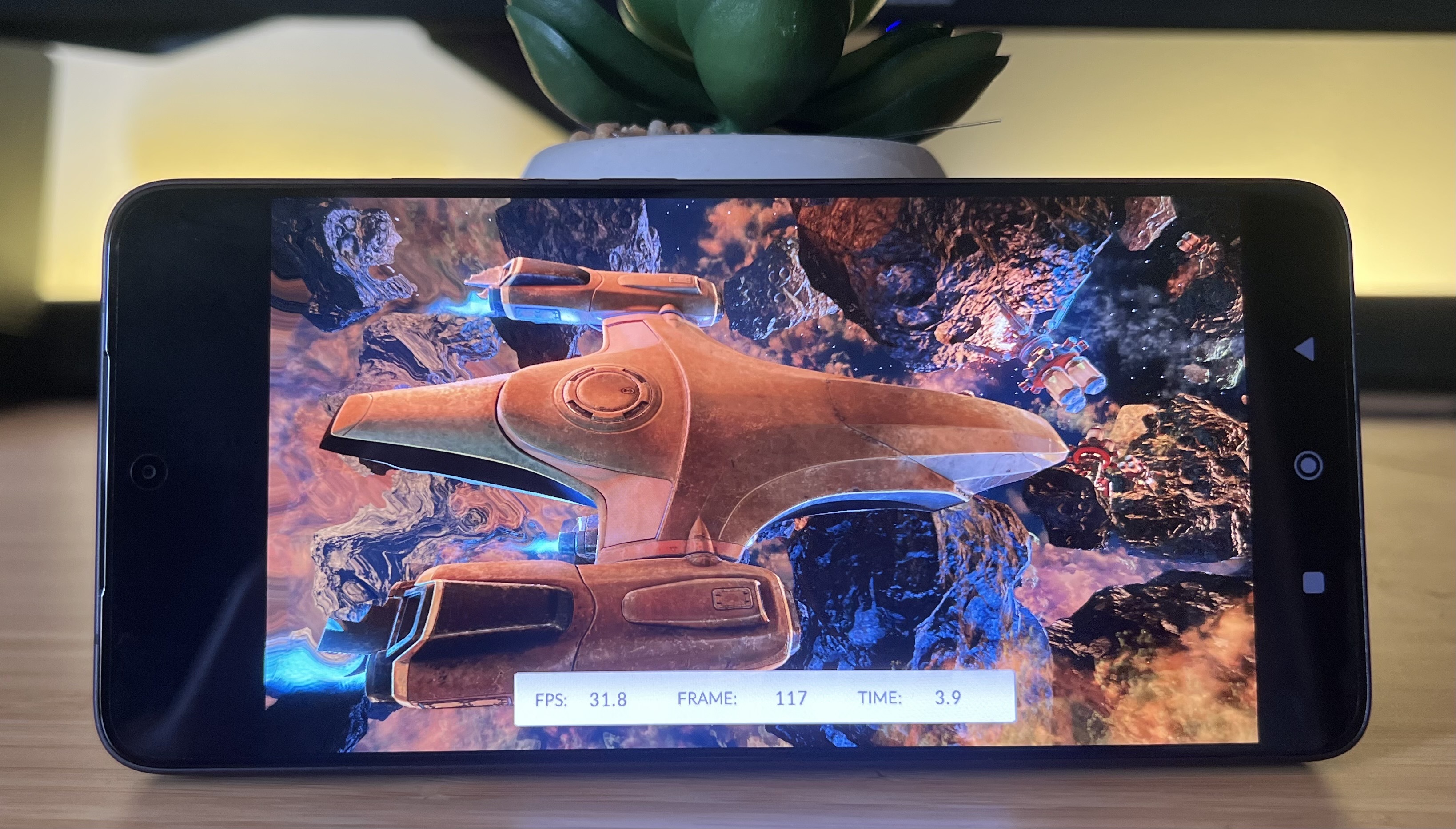 Poco F7 Pro phone running 3D Mark benchmark on a wooden desk