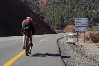 Image shows Stefan cycling towards Marrakech