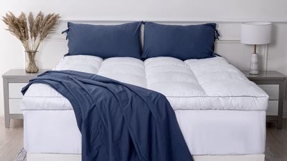 Amazon mattress topper on bed with blue throw 
