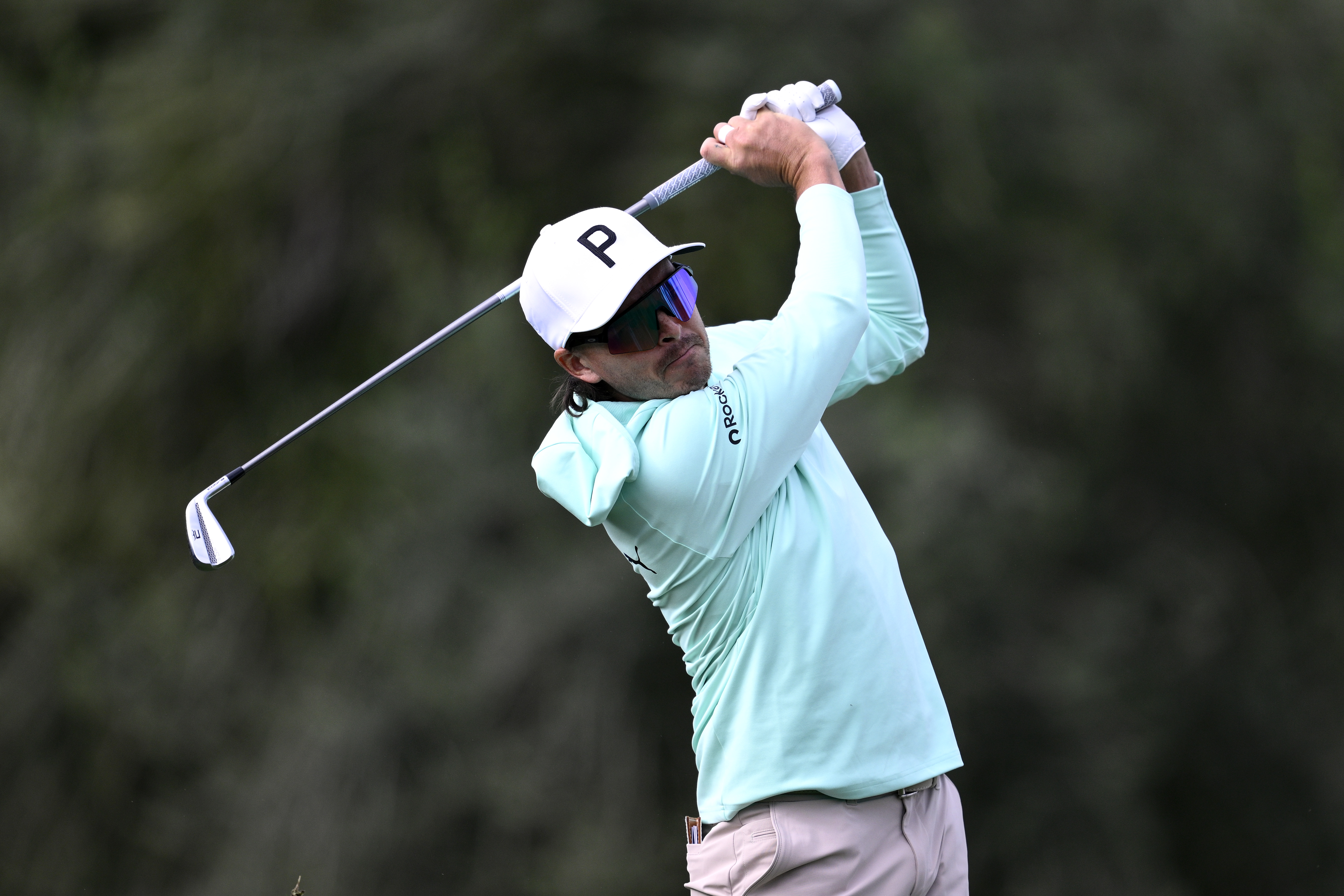 Rickie Fowler hits an iron shot