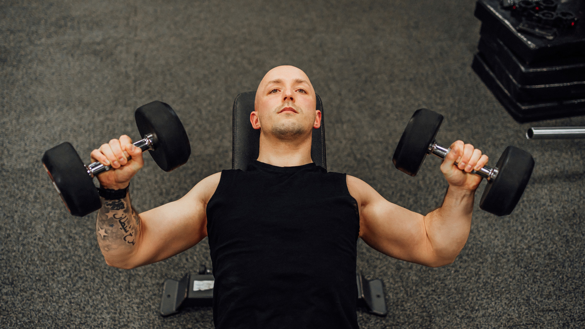 A man doing dumbbell incline press
