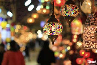 Bright, colorful lamps hung against blurred background, by DDieschburg