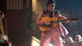 Austin Butler performing in a pink suit in Elvis.