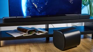 the jbl bar 1300xmk2 in black photographed against the blue tom's guide background