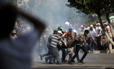 People carry the body of a man shot by Egyptian troops in Cairo on July 5.