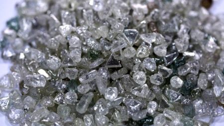 A pile of colorless and colored uncut diamonds sit on a sorting table during processing at DTC Botswana, a unit of De Beers, in Gaborone, Botswana, on Thursday, Oct. 25, 2012. De Beers, the biggest diamond producer by revenue, is moving the sorting and trading of rough stones to Botswana from London to secure access to the world's largest supplier of diamonds by value and challenge Antwerp's dominance as the world's biggest trading hub for rough diamonds