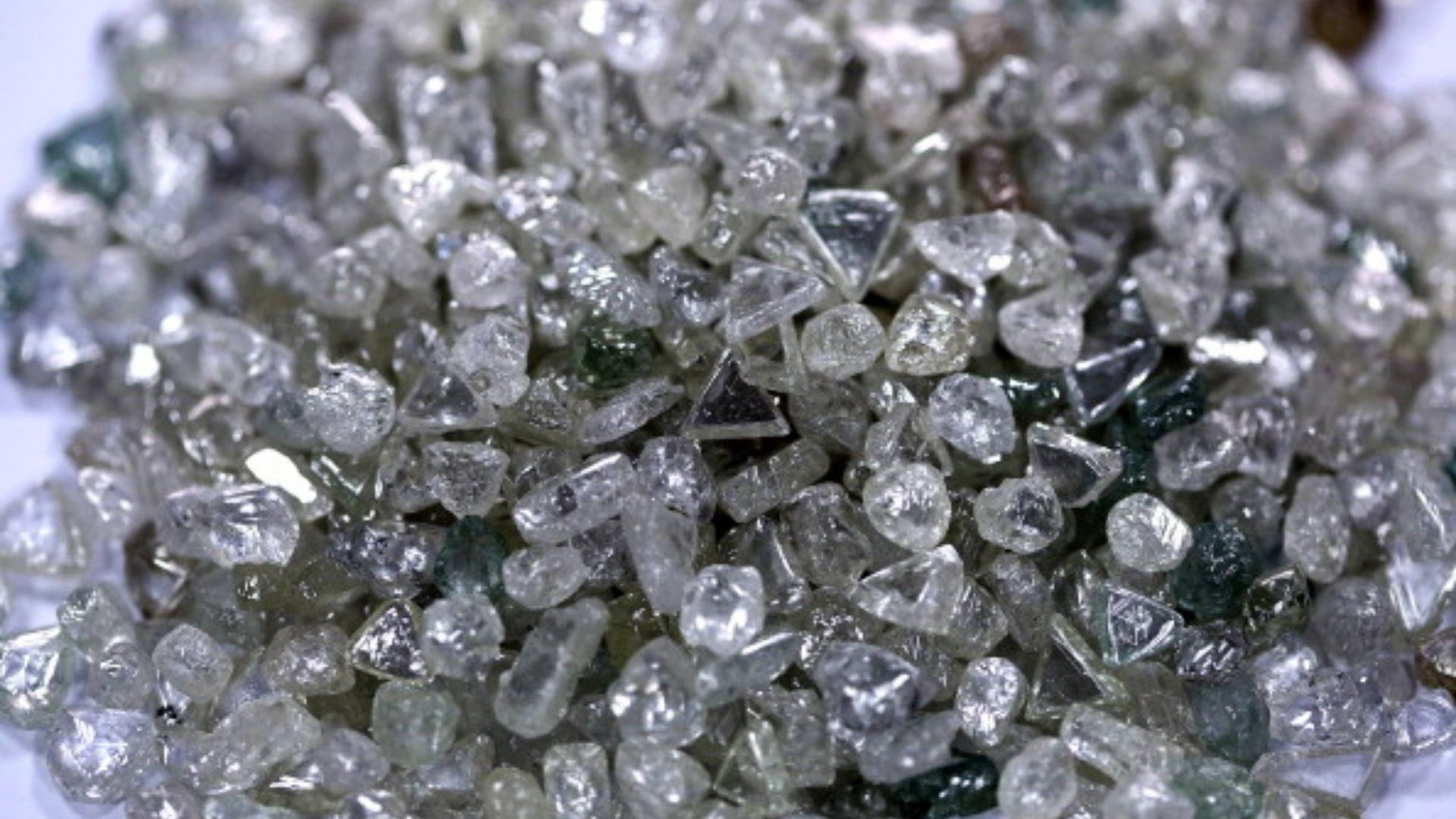A pile of colorless and colored uncut diamonds sit on a sorting table during processing at DTC Botswana, a unit of De Beers, in Gaborone, Botswana, on Thursday, Oct. 25, 2012. De Beers, the biggest diamond producer by revenue, is moving the sorting and trading of rough stones to Botswana from London to secure access to the world's largest supplier of diamonds by value and challenge Antwerp's dominance as the world's biggest trading hub for rough diamonds