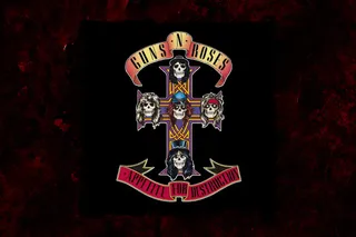 The cover of Appetite for Destruction by Guns N' Roses. It shows a cross with ribbons at the top and bottom displaying the band name and album title, with five skulls representing the members of the band.