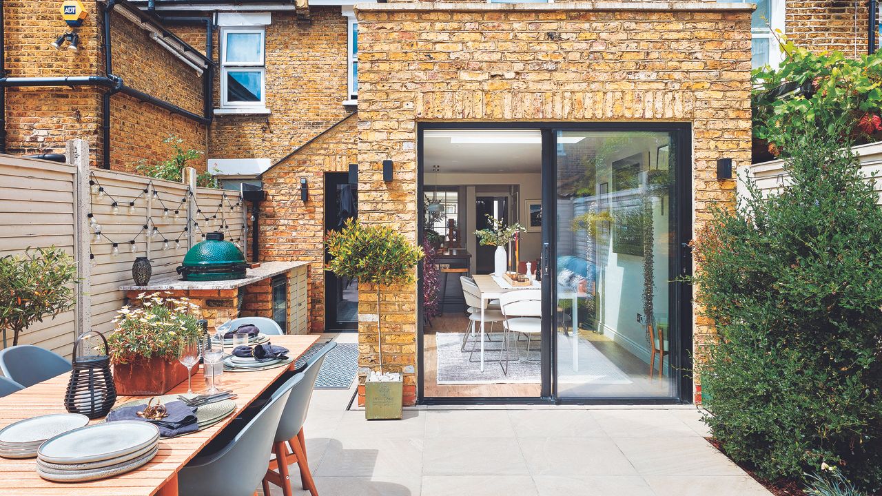 Rear house extension with patio and outdoor table