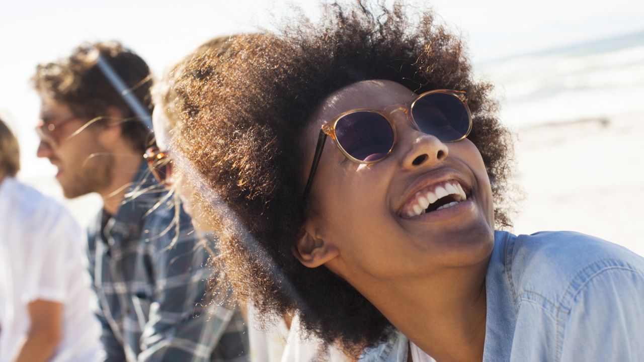 Woman on a beach wearing sunglasses