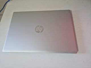 A silver HP Pavilion 16 sitting on a white desk