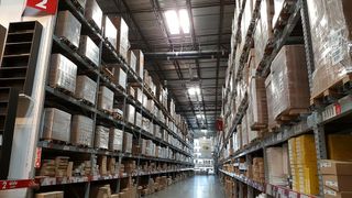 A warehouse storing shelves of goods.