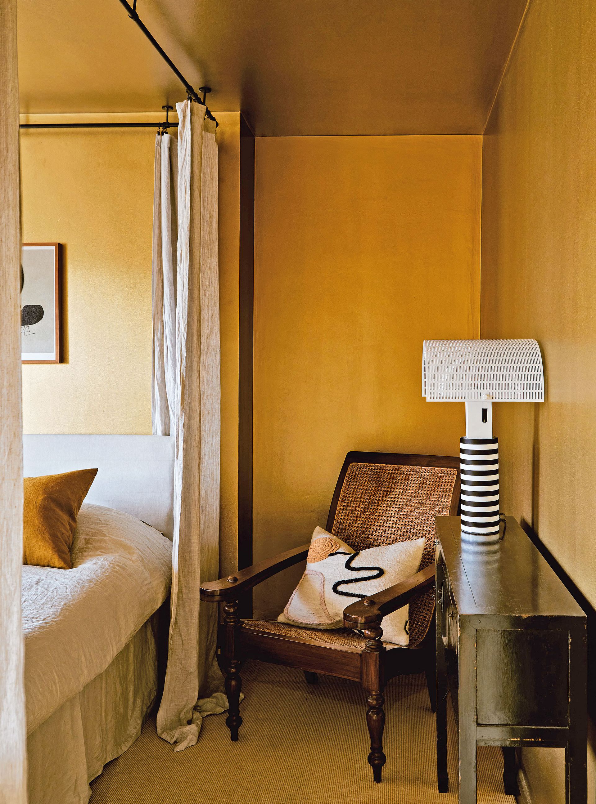 Gold bedroom with gold ceiling and metal bed