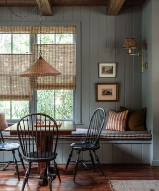 blue shiplapped dining room with wood paneled ceiling and a rustic dining bench seat