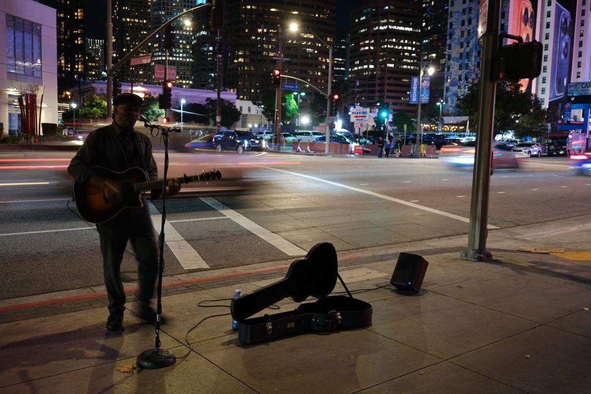 A musician plays guitar on the streets of downtown Los Angeles, taken with the FUjifilm XF 23mm f/2.8 R WR and X-E5
