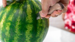 Cutting watermelon in half